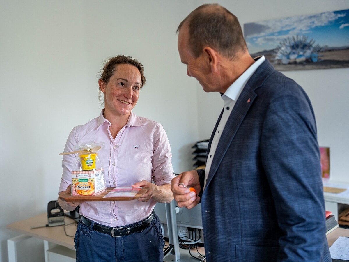 A man gives a woman a gift.