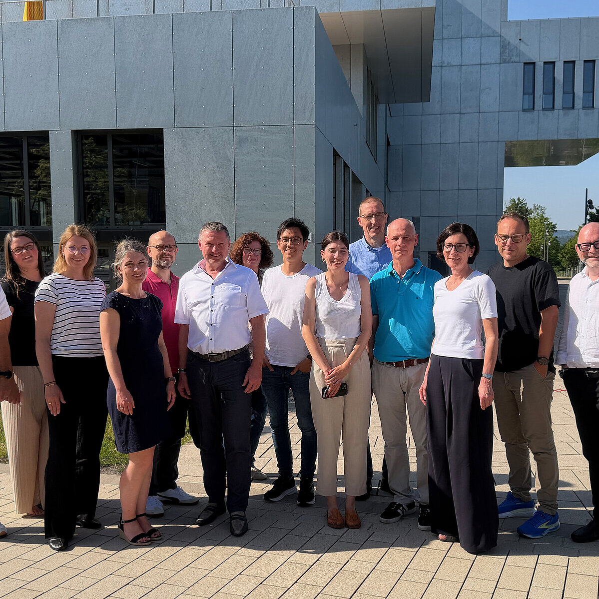 Worms University of Applied Sciences Learns About Modern Service Organization at TH OWL Group photo: 14 people are standing in front of InnovationSPIN on the Camous in Lemgo.