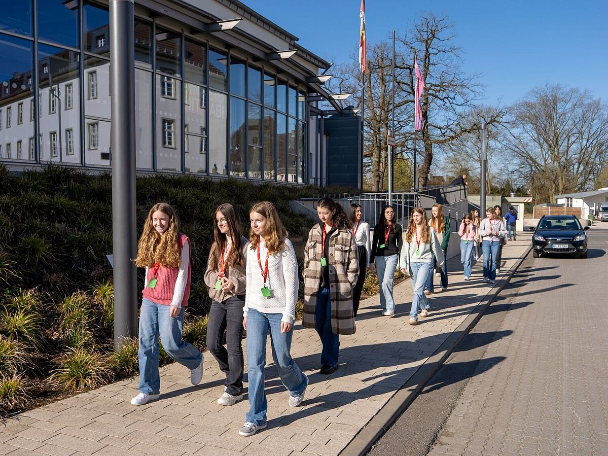 Eine große Gruppe von Mädchen erkundet den Campus zu Fuß. 